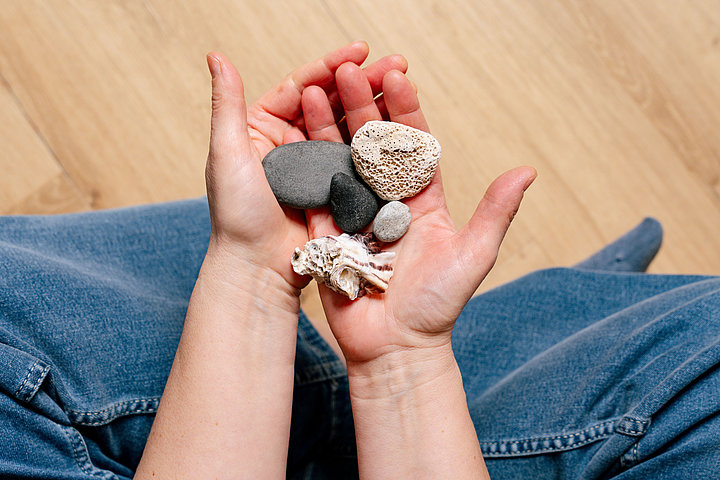 Dr. Johanna Sohm hat verschiedene Steine und Muscheln in der Hand.